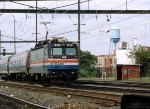 Amtrak AEM-7 #910 passes through the Frankford Junction station with an eastbound